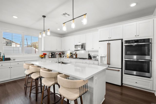 835 Orangedale Ave, Redlands, CA 92374 - kitchen with appliances with stainless steel finishes, light countertops, dark wood finished floors, and a sink