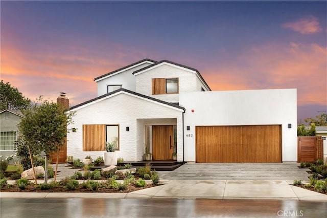 482 Costa Mesa St, Costa Mesa, CA 92627 - view of front of home featuring an attached garage, brick siding, and a chimney