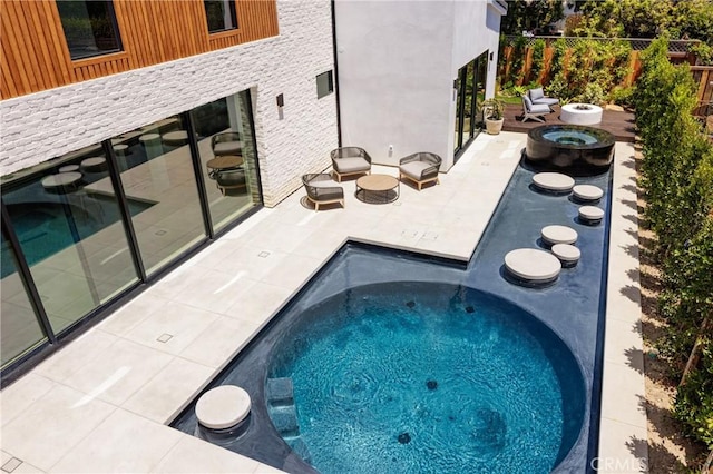 482 Costa Mesa St, Costa Mesa, CA 92627 - view of swimming pool featuring a hot tub, an outdoor fire pit, a patio area, and fence