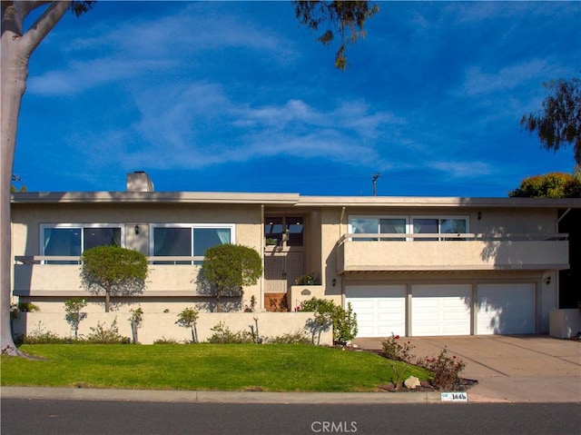 1446 Via Castilla, Palos Verdes Estates, CA 90274 - view of front facade featuring stucco siding, concrete driveway, an attached garage, and a front lawn