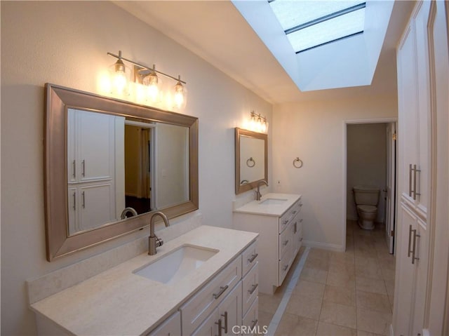 1446 Via Castilla, Palos Verdes Estates, CA 90274 - full bath featuring a skylight, two vanities, tile patterned flooring, toilet, and baseboards