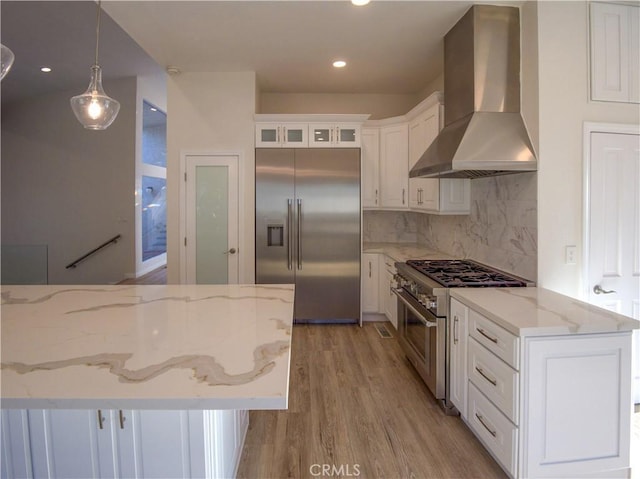 1446 Via Castilla, Palos Verdes Estates, CA 90274 - kitchen with premium appliances, wall chimney range hood, light wood-style flooring, white cabinetry, and tasteful backsplash