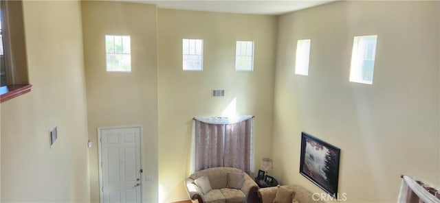 foyer entrance featuring visible vents, plenty of natural light, and a towering ceiling
