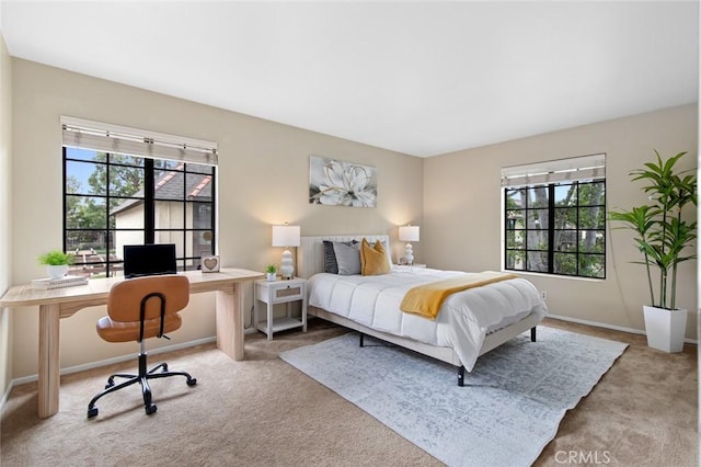 bedroom featuring carpet and baseboards
