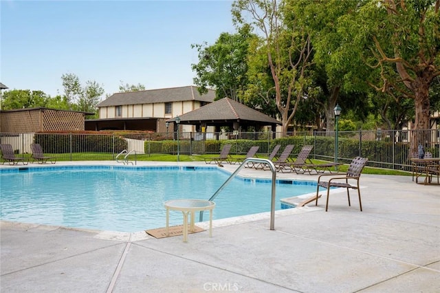 pool with a gazebo, a patio area, and fence