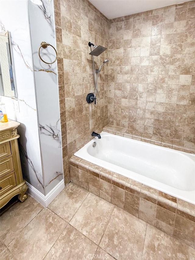 full bathroom featuring tiled shower / bath combo and vanity