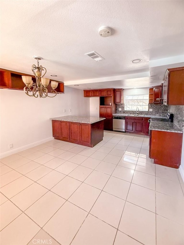 kitchen with decorative backsplash, a sink, visible vents, stainless steel appliances, and a chandelier