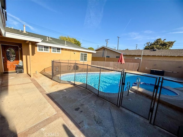 view of pool featuring fence, a fenced in pool, and a patio area