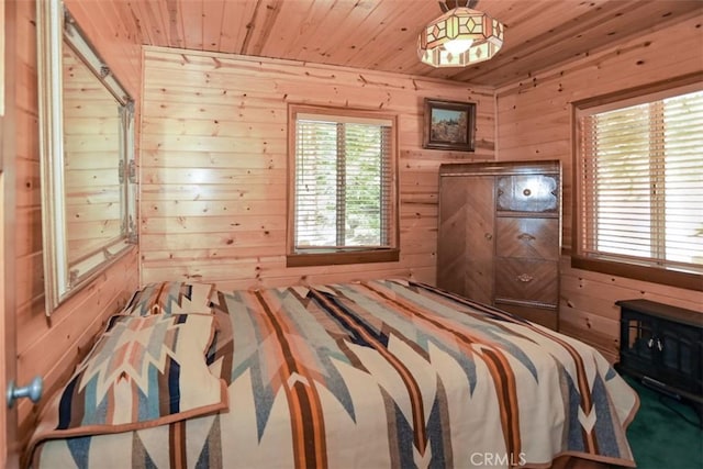 bedroom featuring wood walls, multiple windows, and wooden ceiling