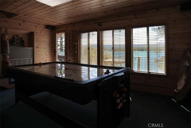 dining room featuring wooden walls and wood ceiling