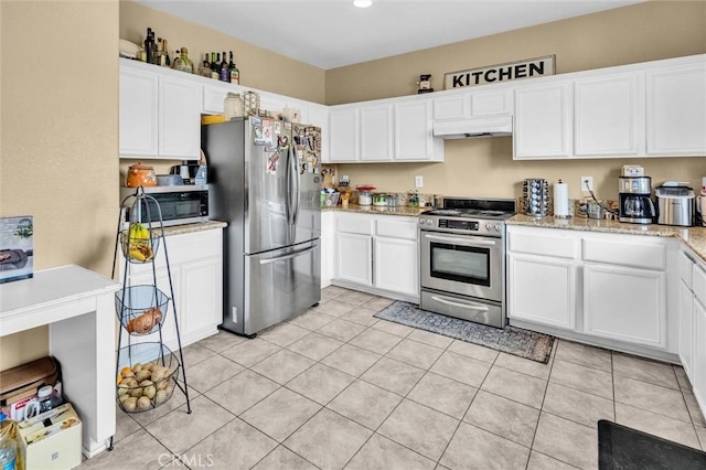 1781 Terrace Ave, Colton, CA 92324 - kitchen featuring light stone countertops, under cabinet range hood, appliances with stainless steel finishes, white cabinetry, and light tile patterned flooring