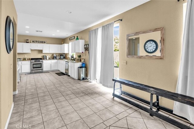 1781 Terrace Ave, Colton, CA 92324 - kitchen with white cabinets, appliances with stainless steel finishes, visible vents, light countertops, and light tile patterned flooring