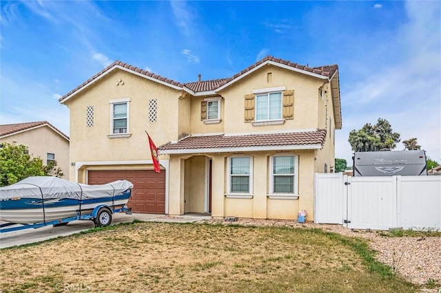 1781 Terrace Ave, Colton, CA 92324 - mediterranean / spanish-style house featuring stucco siding, a tiled roof, a gate, fence, and an attached garage