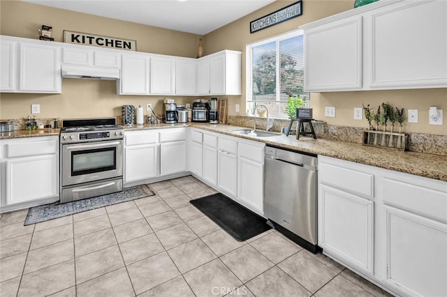 1781 Terrace Ave, Colton, CA 92324 - kitchen with a sink, under cabinet range hood, light tile patterned floors, white cabinets, and appliances with stainless steel finishes