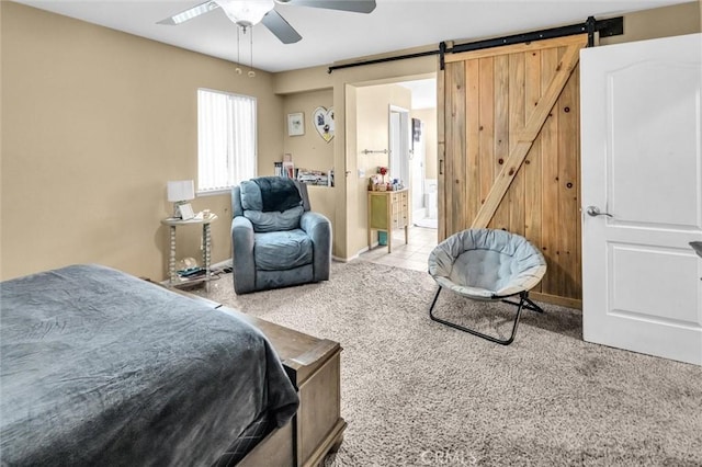 1781 Terrace Ave, Colton, CA 92324 - carpeted bedroom with a barn door, a ceiling fan, ensuite bath, and baseboards