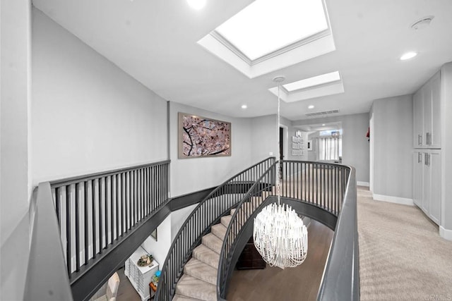 14 Buccaneer Way, Coronado, CA 92118 - staircase with a chandelier, visible vents, carpet, baseboards, and a skylight
