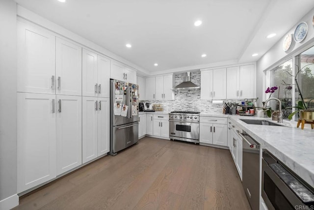 14 Buccaneer Way, Coronado, CA 92118 - kitchen with wall chimney range hood, white cabinetry, recessed lighting, wood finished floors, and high end appliances