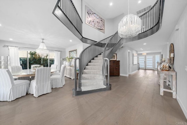 14 Buccaneer Way, Coronado, CA 92118 - unfurnished dining area featuring visible vents, wood finished floors, a notable chandelier, and stairs