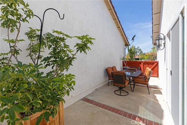 view of patio featuring fence and outdoor dining space
