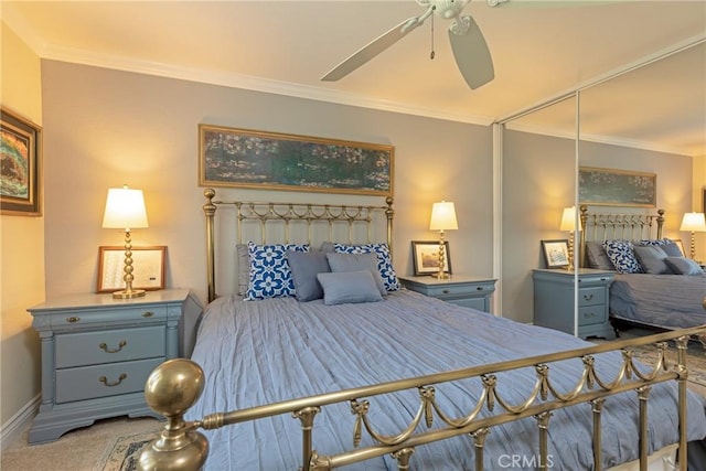 carpeted bedroom with ornamental molding, a ceiling fan, and baseboards
