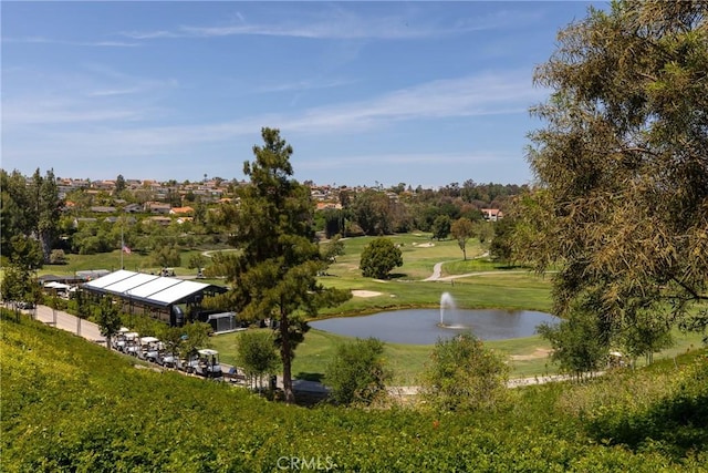 surrounding community with view of golf course, a water view, and a lawn
