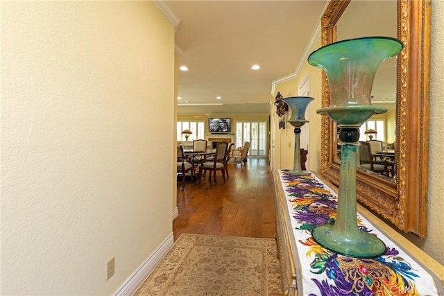 corridor featuring crown molding, recessed lighting, hardwood / wood-style floors, and baseboards