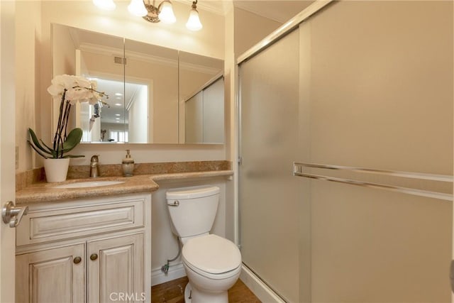 full bath with toilet, vanity, a shower stall, and crown molding