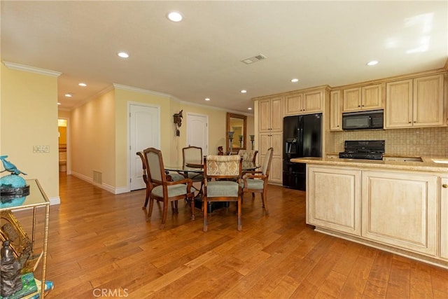 kitchen with recessed lighting, tasteful backsplash, crown molding, black appliances, and visible vents