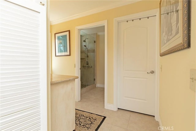 hallway featuring crown molding and light tile patterned floors