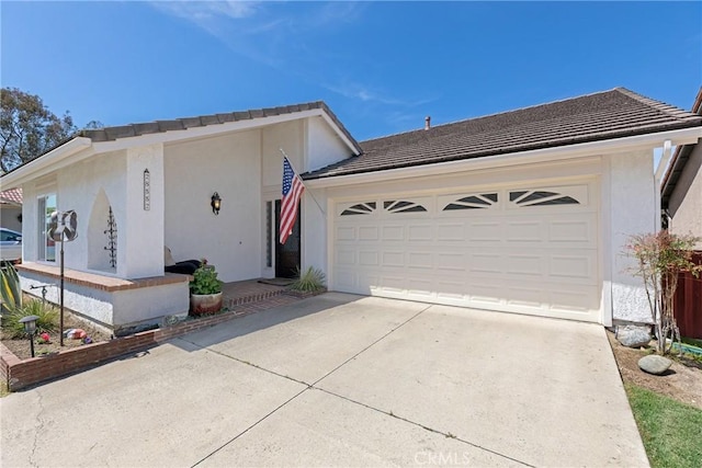 single story home featuring stucco siding, a tile roof, driveway, and an attached garage