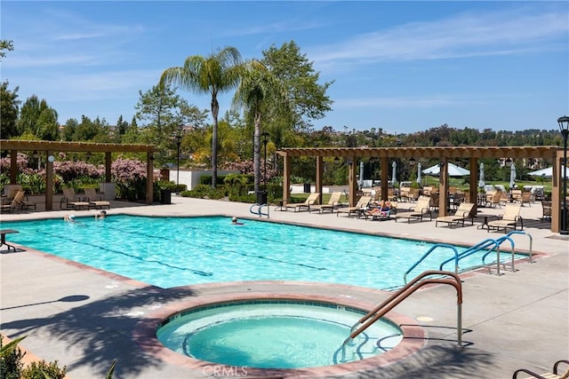 pool featuring a patio and a hot tub