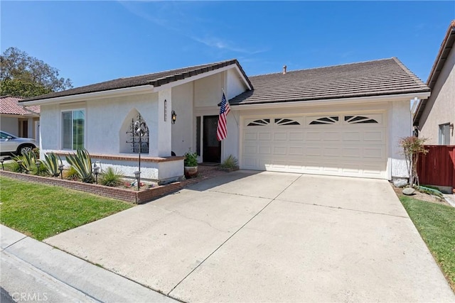 ranch-style home with stucco siding, driveway, a tiled roof, and an attached garage