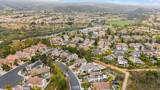 birds eye view of property featuring a water and mountain view and a residential view