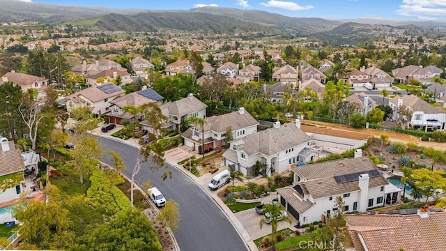 drone / aerial view featuring a residential view and a mountain view