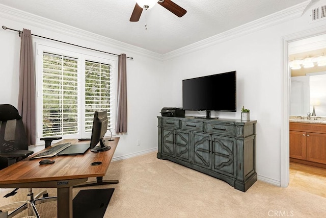 office featuring visible vents, ornamental molding, a ceiling fan, and light carpet