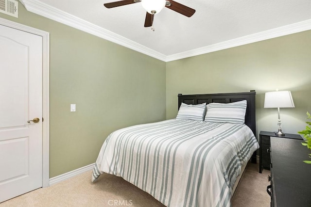 carpeted bedroom with visible vents, a ceiling fan, baseboards, and crown molding