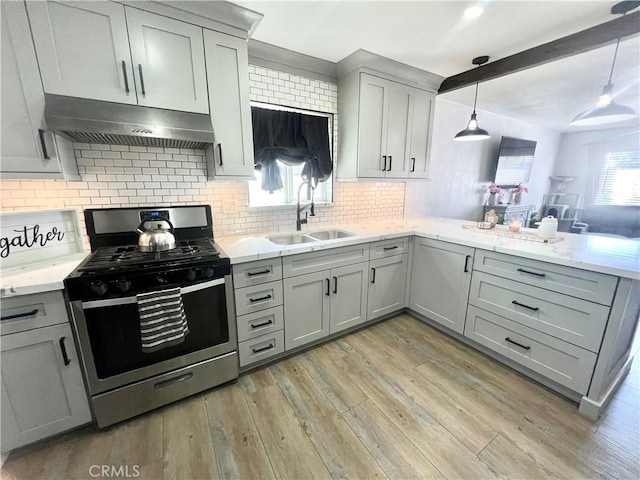 583 W G St, Colton, CA 92324 - kitchen with gray cabinets, tasteful backsplash, gas stove, a sink, and under cabinet range hood