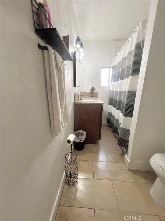 583 W G St, Colton, CA 92324 - bathroom featuring curtained shower, baseboards, tile patterned floors, vanity, and toilet