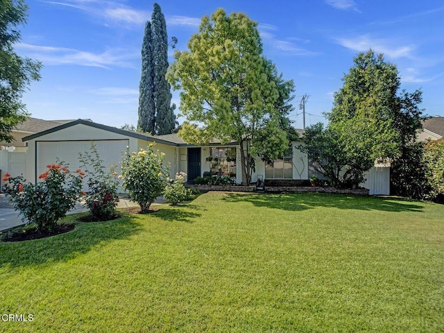 single story home with a front yard and a garage