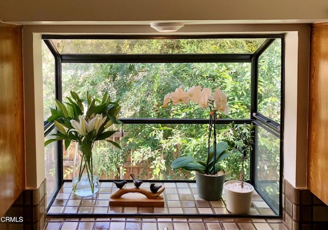 entryway featuring a sunroom and plenty of natural light