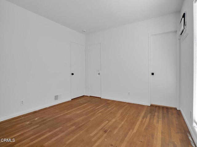 966 E Edgecomb St, Covina, CA 91724 - unfurnished bedroom with baseboards, wood finished floors, and visible vents