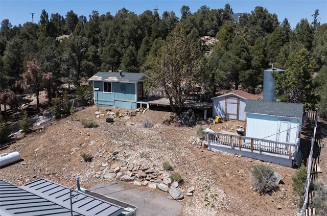 view of yard with a storage unit, an outdoor structure, and a wooden deck