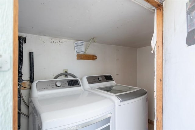 clothes washing area with washing machine and dryer and laundry area