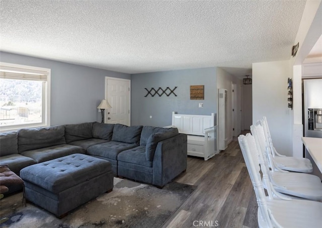 living area with wood finished floors and a textured ceiling