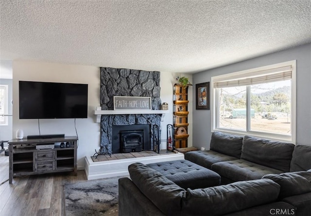 living room with a textured ceiling, wood finished floors, and a wealth of natural light