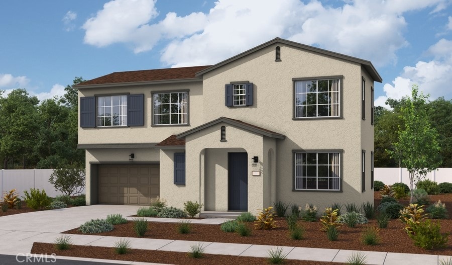 traditional-style house featuring fence, driveway, stucco siding, and a garage