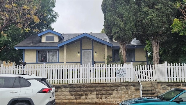 view of front of house featuring a fenced front yard and stucco siding