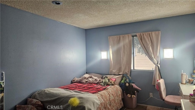 carpeted bedroom featuring a textured ceiling
