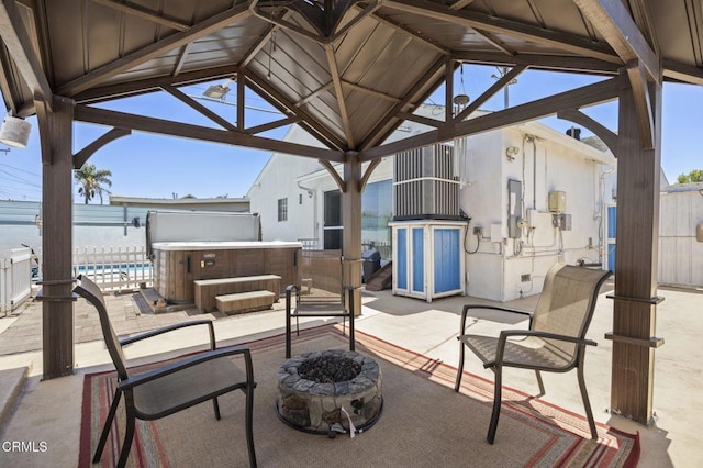 1213 Doris Ave, Oxnard, CA 93030 - view of patio featuring a hot tub, a gazebo, an outdoor fire pit, fence, and a swimming pool