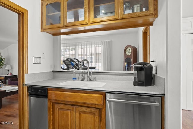 1213 Doris Ave, Oxnard, CA 93030 - kitchen featuring dishwasher, a sink, brown cabinets, light countertops, and glass insert cabinets